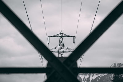 Low angle view of silhouette bridge against sky