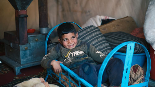 Portrait of boy playing in slide