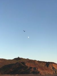 Low angle view of mountain against clear blue sky