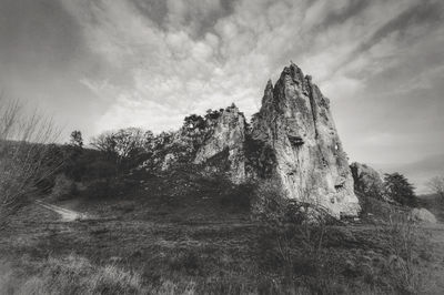 Low angle view of rocks on land against sky