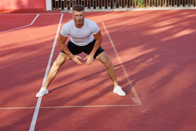 Low section of woman exercising on court