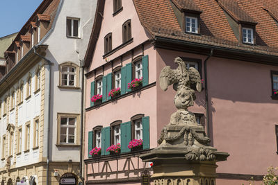 Old half timbered houses and an eagle statue in the center of the city of bamberg, germany