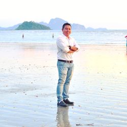 Portrait of man standing on shore at beach