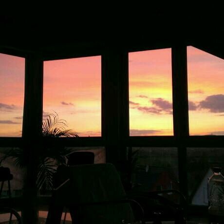 sunset, window, orange color, sky, indoors, silhouette, built structure, architecture, cloud - sky, glass - material, horizon over water, transparent, nature, sea, house, scenics, cloud, no people, beauty in nature, dark