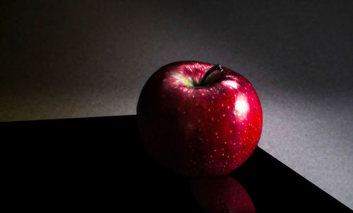 High angle view of apple on table against wall