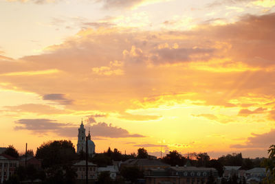 Buildings against sky during sunset