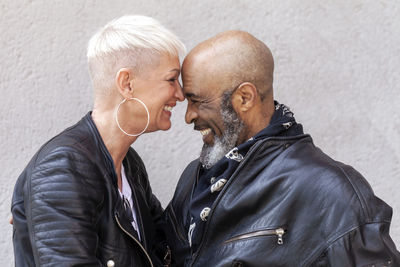Affectionate mature biker couple in leather clothes