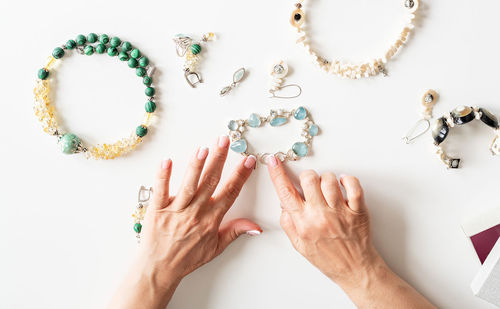 High angle view of woman hand on white background