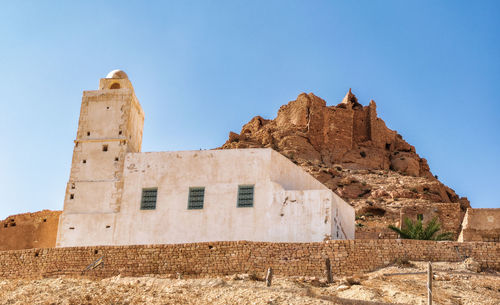 Low angle view of castle against clear blue sky