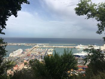 High angle view of townscape by sea against sky