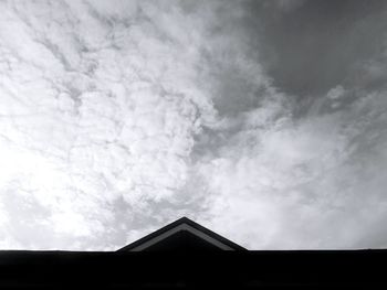 Low angle view of building against cloudy sky