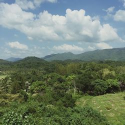 Scenic view of mountains against cloudy sky