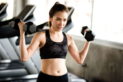 Young woman exercising at gym