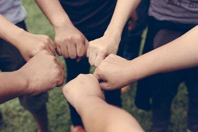 High angle view of friends fist bumping