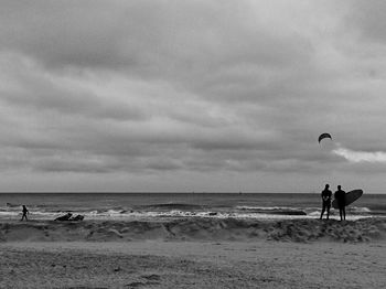 People on beach against sky