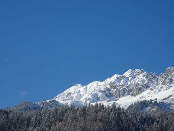 Scenic view of snowcapped mountains against clear blue sky