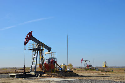 Construction site on field against clear blue sky