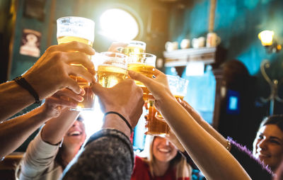 Friends toasting beer in restaurant