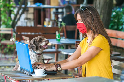 Woman with dog on table