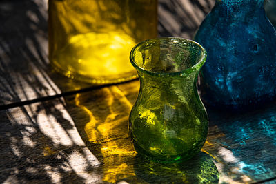 Close-up of yellow drinking glass on table