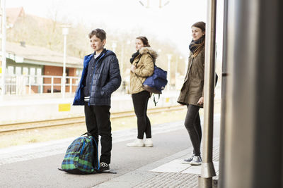 School students waiting for train at station