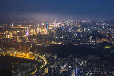 High angle view of illuminated buildings against sky at night