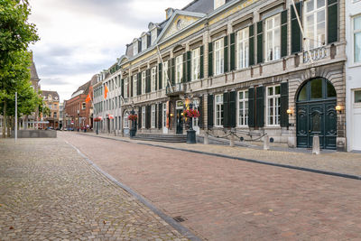 Street amidst buildings in city against sky