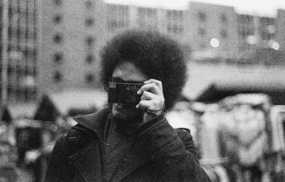 Close-up of woman photographing through mobile phone