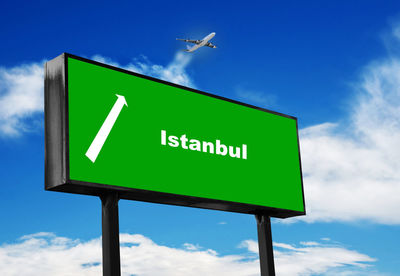 Low angle view of road sign against sky