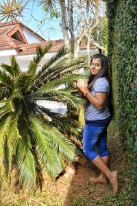 Woman standing against plants