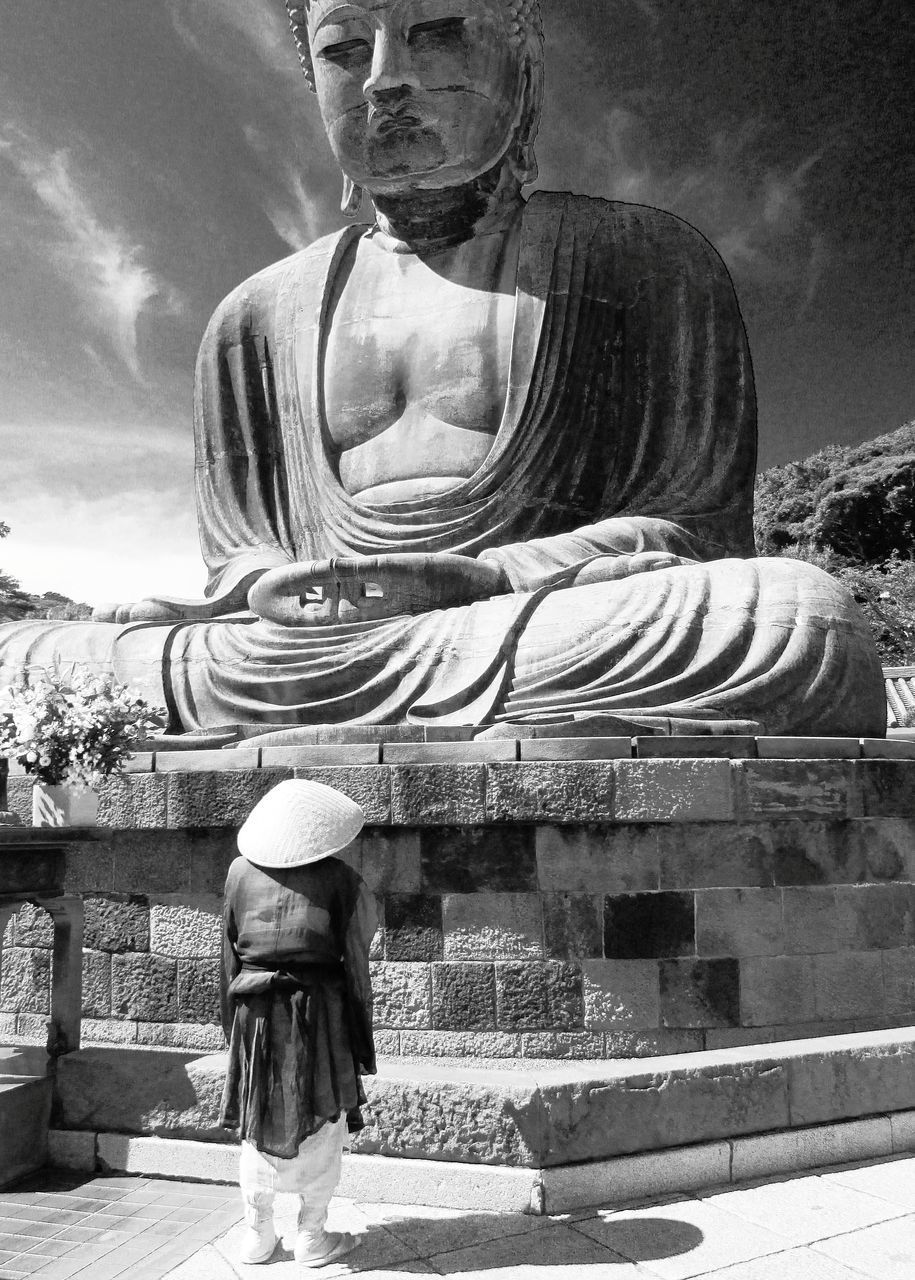 STATUE OF BUDDHA AGAINST TEMPLE