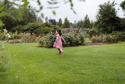 Young girl playing in the summer forest park