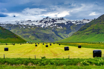 Scenic view of field and mountains against sky