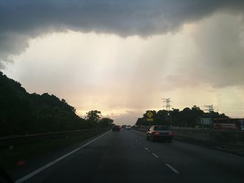 Cars on road against sky