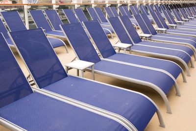 High angle view of empty blue deck chairs