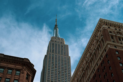 Low angle view of buildings against cloudy sky