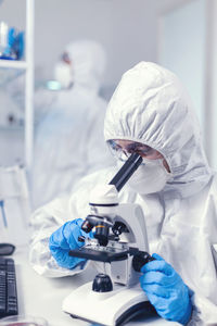 Midsection of scientist working in laboratory