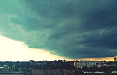 Cityscape against cloudy sky