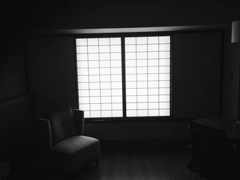 Empty armchair in room against window