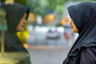 Portrait of a young woman in city