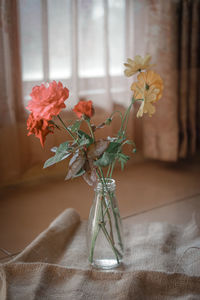 Close-up of flower vase on table at home