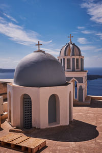 Small church of st. mark the evangelist with its blue dome and colorful bell tower - santorini