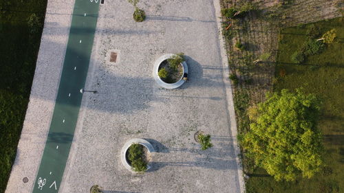 High angle view of manhole on grass by road