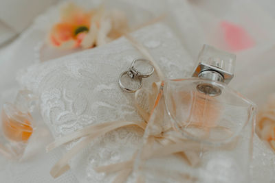 Close-up of wedding rings on white table