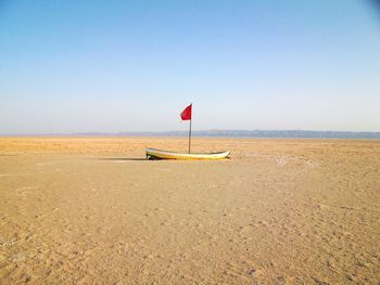 Lifeguard hut on beach against clear sky