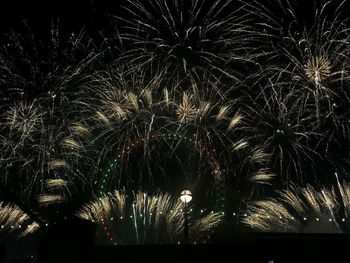 Low angle view of firework display at night