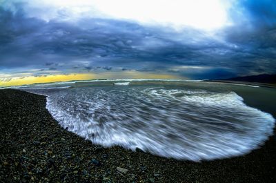 Scenic view of sea against cloudy sky