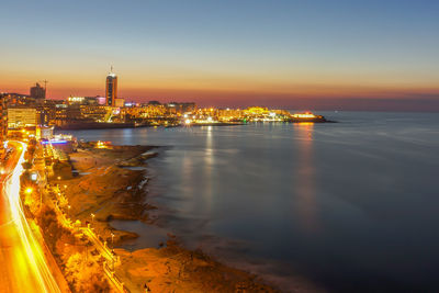 Aerial view of city lit up at night