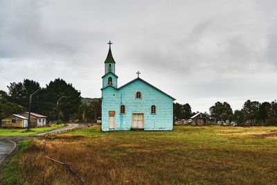 House on field against sky