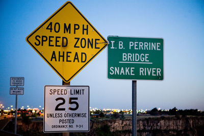 Low angle view of various road sign against clear sky